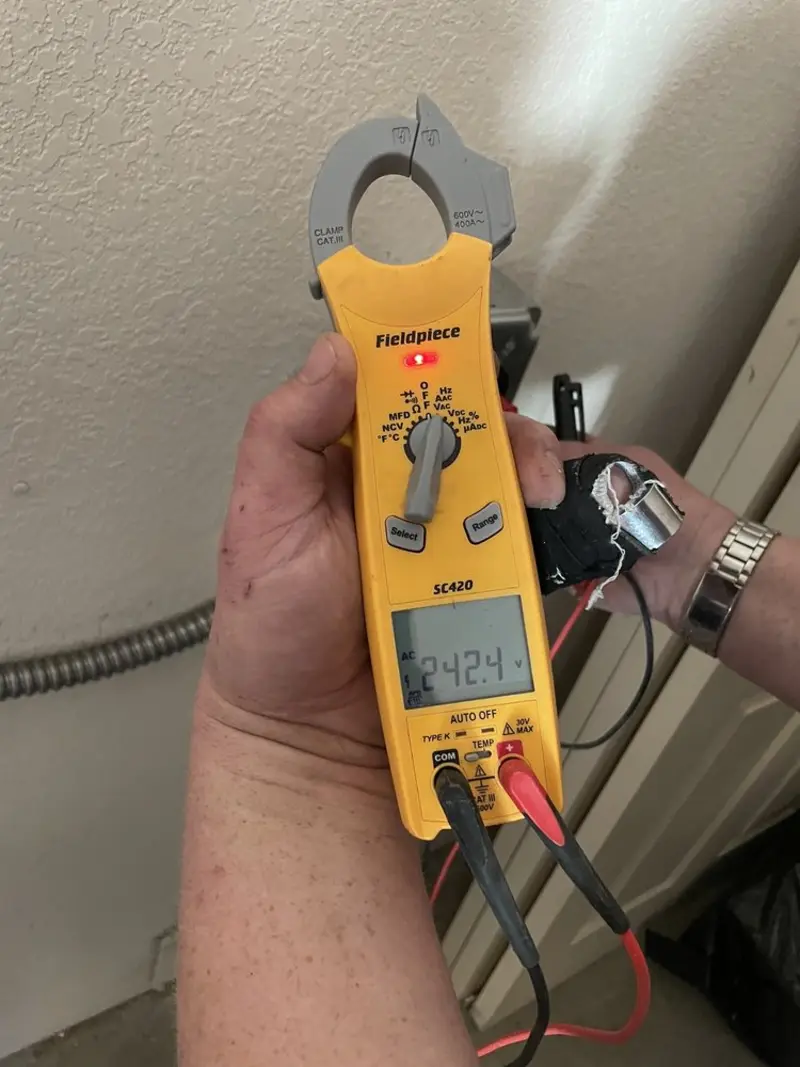 Voltage testing with clamp meter during Ceiling Fan Installation in Clarksville
